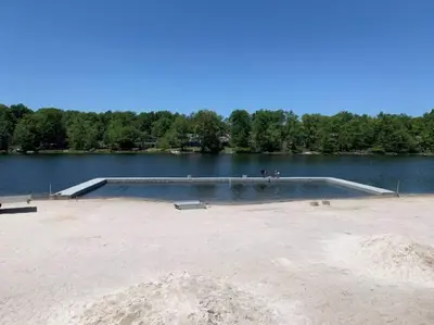 a swimming pool in the middle of a lake at The Family Getaway in Tobyhanna