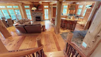 an overhead view of a living room and kitchen in a log cabin at Cayuga Lodge South in Cooperstown