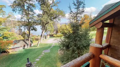 a view of a yard from a porch of a house at Oneida Lodge North in Cooperstown