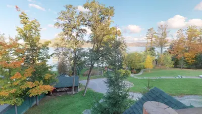 an aerial view of a yard with a lake at Oneida Lodge North in Cooperstown