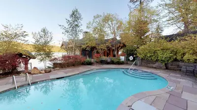 a swimming pool in a yard with a house at Oneida Lodge North in Cooperstown