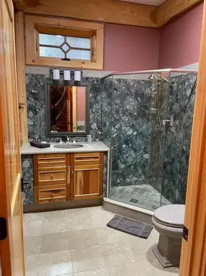 a bathroom with a shower and a toilet and a sink at Seneca Lodge in Cooperstown