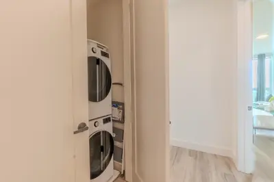 a room with three microwaves in a wall at Emerald Escape, Free Parking, 2 Bath, Sleeps 8 Near American Dream and The Airport, King Bed and 2 Queen Beds, Washer and Dryer in Orange
