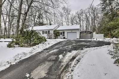 a house in the snow with a driveway at Hadley Vacation Rental 24 Mi to Springfield! in Hadley