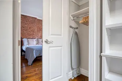 a door leading to a bedroom with a brick wall at UES 3br penthouse w wd nr Central Park NYC-1110 in New York