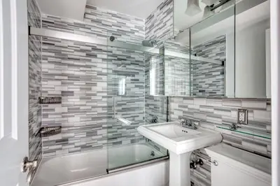 a bathroom with a sink and a shower and a tub at UES 3br penthouse w wd nr Central Park NYC-1110 in New York