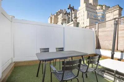a table and chairs on a balcony with a fence at UES 3br penthouse w wd nr Central Park NYC-1110 in New York