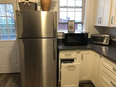 a kitchen with a stainless steel refrigerator and a microwave at Private Rooms in TownHouse w Shared Baths Qn Bed 1-3ppl in Unionport