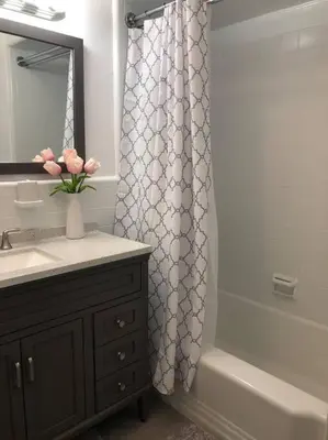 a bathroom with a sink and a shower curtain at Private Rooms in TownHouse w Shared Baths Qn Bed 1-3ppl in Unionport