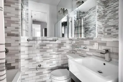 a bathroom with a tub and a toilet and a sink at East Village 1br w wd nr cafes NYC-1115 in New York