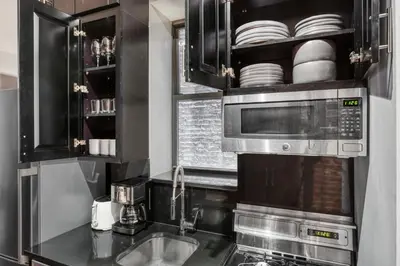 a kitchen with a sink and a microwave at East Village 1br w wd nr cafes NYC-1115 in New York