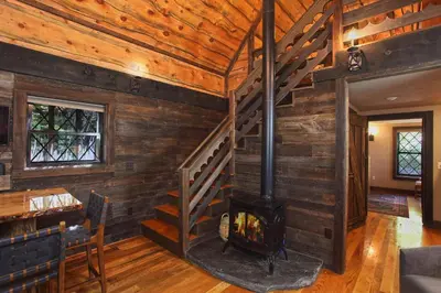 a living room with a fireplace in a log cabin at Vikings Villages Resort in Guilford