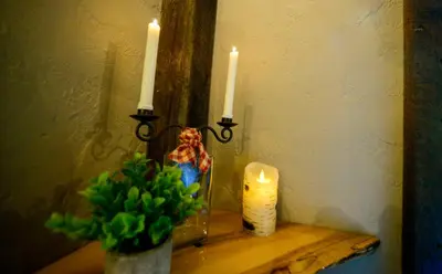 a table with two candles and a vase with a plant at Vikings Villages Resort in Guilford
