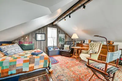 a bedroom with a bed and a desk and chairs at Cozy Catskills Vacation Rental with Deck! in Fleischmanns