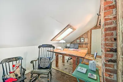 a dining room with a table and two chairs at Cozy Catskills Vacation Rental with Deck! in Fleischmanns