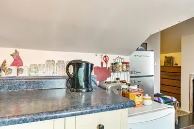 a kitchen with a counter top and a refrigerator at Cozy Catskills Vacation Rental with Deck! in Fleischmanns