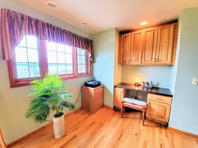 a kitchen with a desk and a potted plant at Artemis Lakehouse - Hot Tub, Lakefront & Racetrack in Saratoga Springs