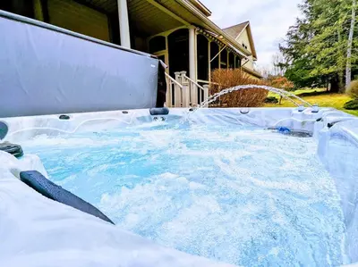 a large jacuzzi tub with a water fountain at Artemis Lakehouse - Hot Tub, Lakefront & Racetrack in Saratoga Springs