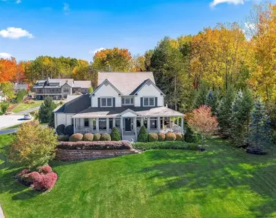 an aerial view of a house with a yard at Artemis Lakehouse - Hot Tub, Lakefront & Racetrack in Saratoga Springs