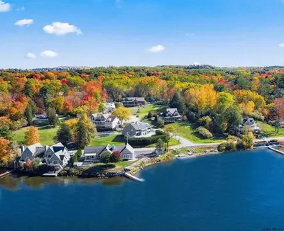an aerial view of a home on a lake at Artemis Lakehouse - Hot Tub, Lakefront & Racetrack in Saratoga Springs