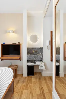 a bedroom with a bed and a tv in a room at UNTITLED at 3 Freeman Alley in New York