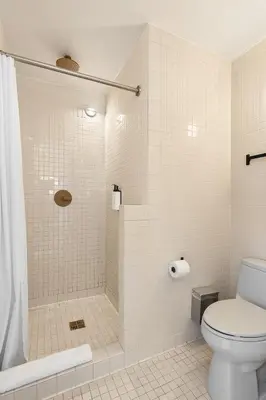 a bathroom with a shower and a toilet at UNTITLED at 3 Freeman Alley in New York