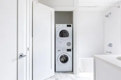 a white laundry room with a washer and dryer at UWS 1BR w Gym Doorman nr Riverside Park NYC-511 in New York