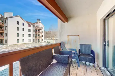 a balcony with chairs and a view of a building at Mountain Village 5H Unit A in Dover