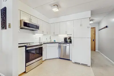 a kitchen with white cabinets and a refrigerator at Mountain Village 5H Unit A in Dover