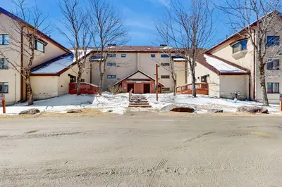 a large white building with snow on the ground at Mountain Village 5H Unit A in Dover