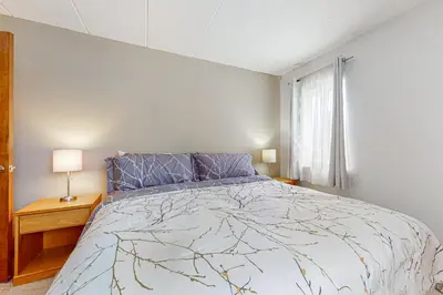 a bedroom with a large bed and a window at Mountain Village #5H in Dover