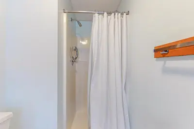 a shower with a white shower curtain in a bathroom at Mountain Village #5H in Dover