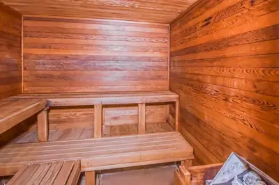 a sauna with wooden walls and benches in a cabin at Mountain Village 5H Unit B in Dover