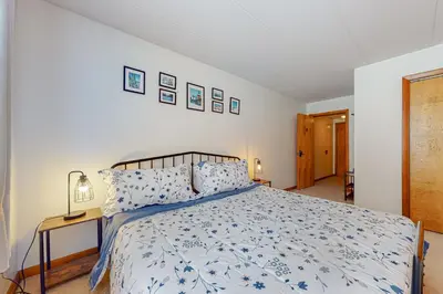 a bedroom with a bed with a blue and white comforter at Mountain Village 5H Unit B in Dover
