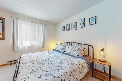 a bedroom with a bed and a window at Mountain Village 5H Unit B in Dover