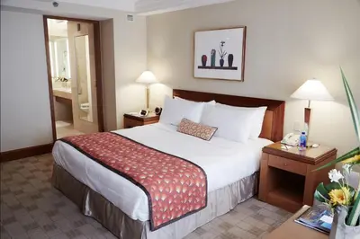 a hotel room with a bed and a bathroom at The Prince Kitano New York in New York