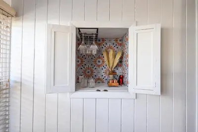 a window in a wall with a vase in it at Cozy Connecticut Beach House in East Haven