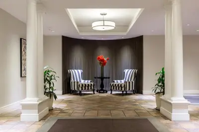 a lobby with three chairs and a table with a vase of flowers at Chelsea 1BR w Gym Concierge nr Penn Stn MSG NYC-439 in New York