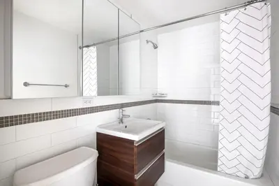 a white bathroom with a sink and a toilet at Chelsea 1BR w Gym Concierge nr Penn Stn MSG NYC-439 in New York
