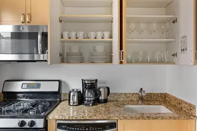 a kitchen with a stove and a sink at 1BR nr Times Sq w Indoor pool Doorman NYC-50 in New York