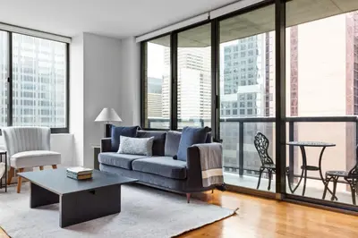a living room with a couch and large windows at 1BR nr Times Sq w Indoor pool Doorman NYC-50 in New York
