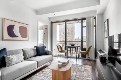 a living room with a couch and a table at UES 2br w wd gym doorman nr Cooper Hewitt NYC-1117 in New York