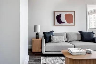 a living room with a couch and a table at UES 2br w wd gym doorman nr Cooper Hewitt NYC-1117 in New York
