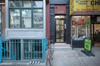 a bike parked on the sidewalk in front of a store at East Village 1br w wd nr Union Sq NYC-936 in New York