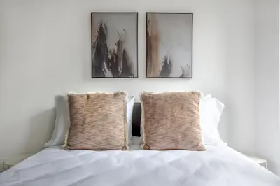a bedroom with three pictures above a bed at East Village 1br w wd nr Union Sq NYC-938 in New York