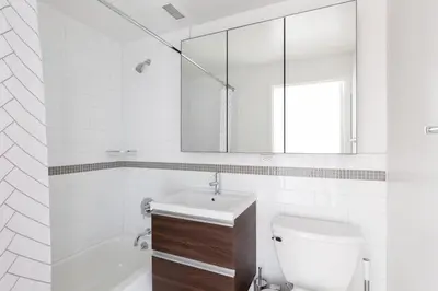 a bathroom with a toilet and a sink and a mirror at Chelsea 1BR w Gym Concierge nr Penn Station NYC-438 in New York