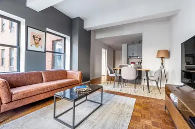 a living room with a couch and a table at Chelsea 1BR w Gym Concierge nr Penn Station NYC-438 in New York