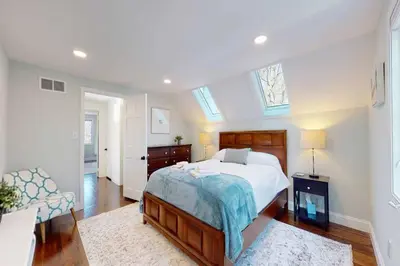 a bedroom with a large bed with a blue blanket at White Oaks in Branford