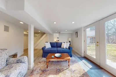 a living room with a blue couch and a table at White Oaks in Branford