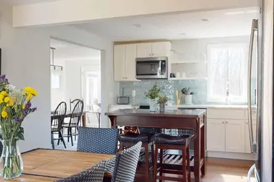 a kitchen with a table and a kitchen with a stove at White Oaks in Branford